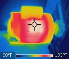 Működő villanymotor hőképe szivárványpalettával: a motortest piros-fehér, a kondenzátorház sárga; a skála 80–133 °F