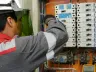 Electrician testing electrical panel