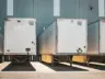 A row of semi trucks parked next to each other