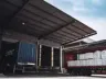 A semi truck is loaded with white bags